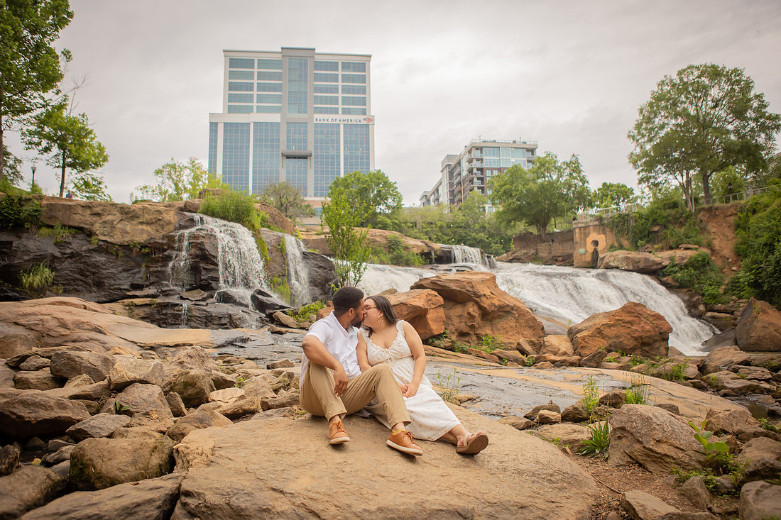 Couple Kissing in front of Waterfall