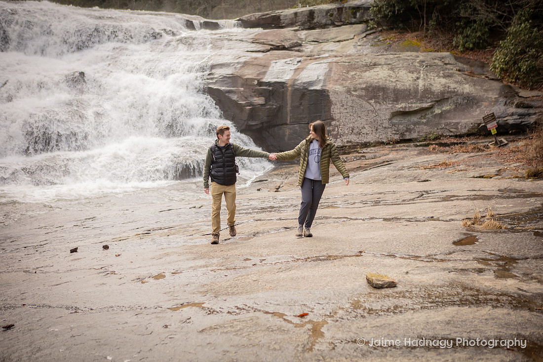 Couple walking near Triple Falls in Brevard NC | WNC Engagement Photographer