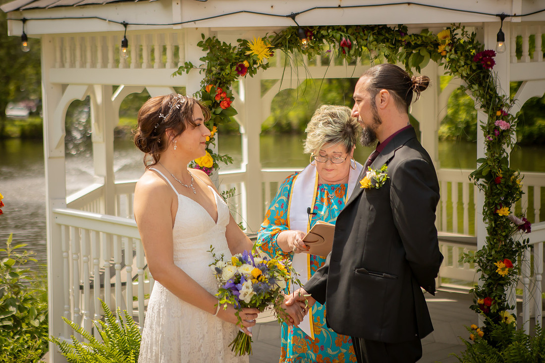 Wedding Photography in front of a White Gazebo and Pond 