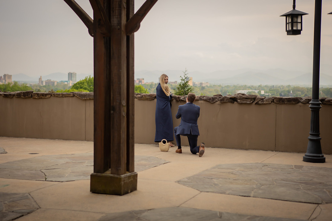 Proposal at Omni Grove Park Inn Vanderbilt Terrace with view of Asheville Downtown | Engagement Photography