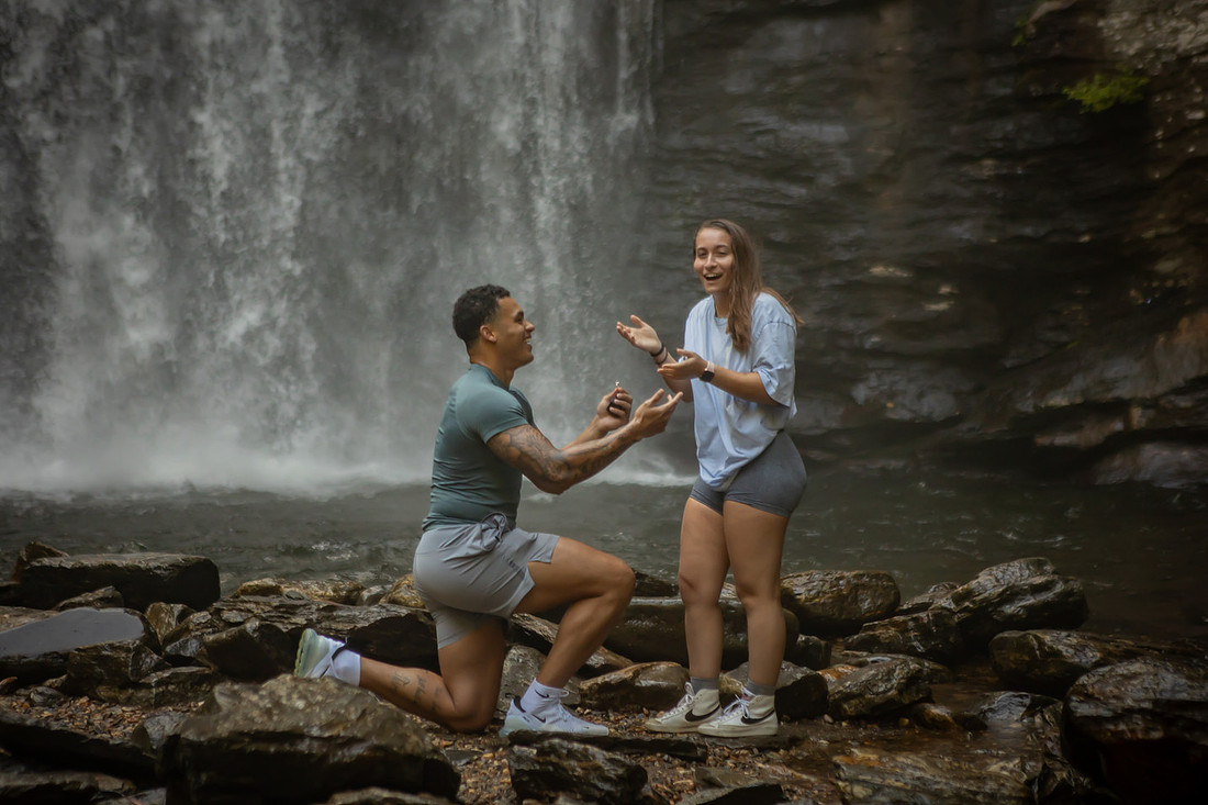 Proposing to his girlfriend at Looking Glass Falls | Asheville Proposal Photographer