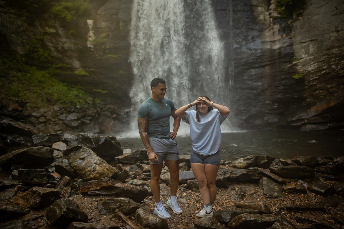 Proposing to his girlfriend at Looking Glass Falls | Asheville Proposal Photographer