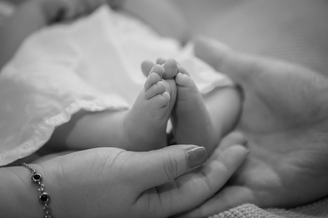 Baby Feet with Parent's Hands in Black and White