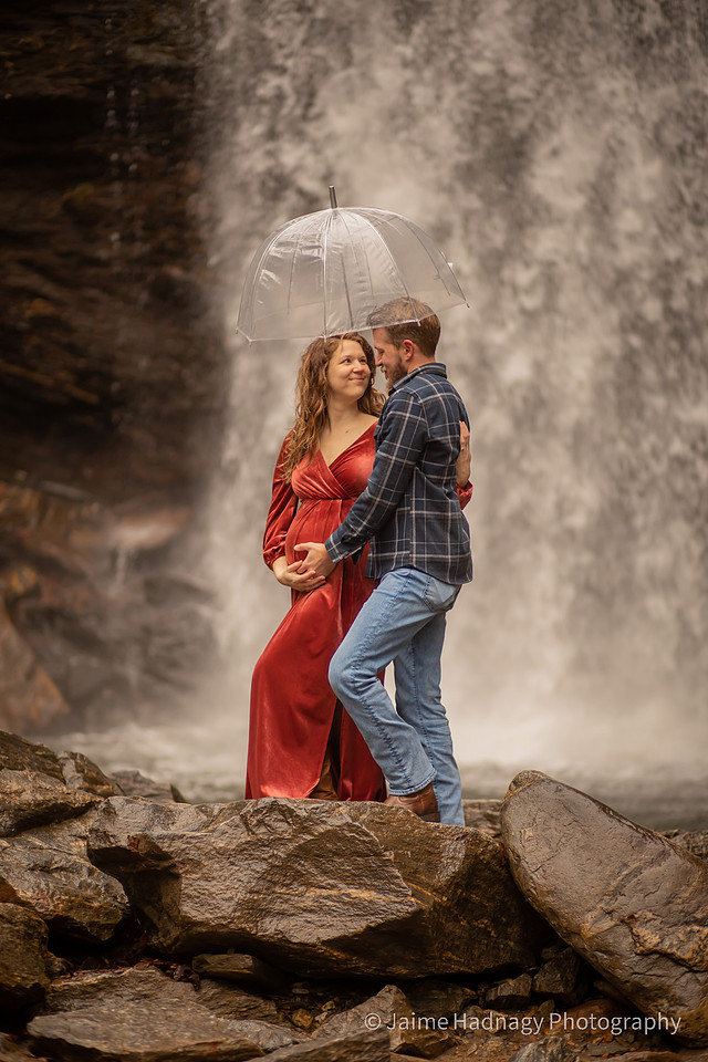 Gorgeous Pregnant Woman at a Waterfall with Umbrella and Red Velvet Dress | North Carolina Photographer