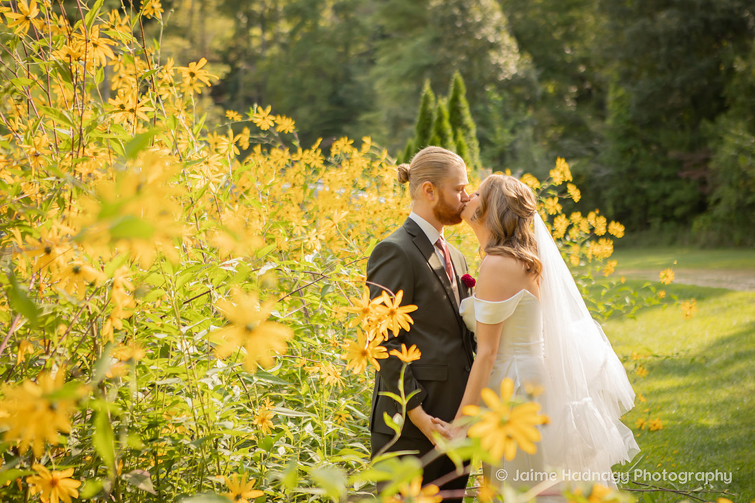Bride and Groom Kissing with Yellow Forsythia Flowers