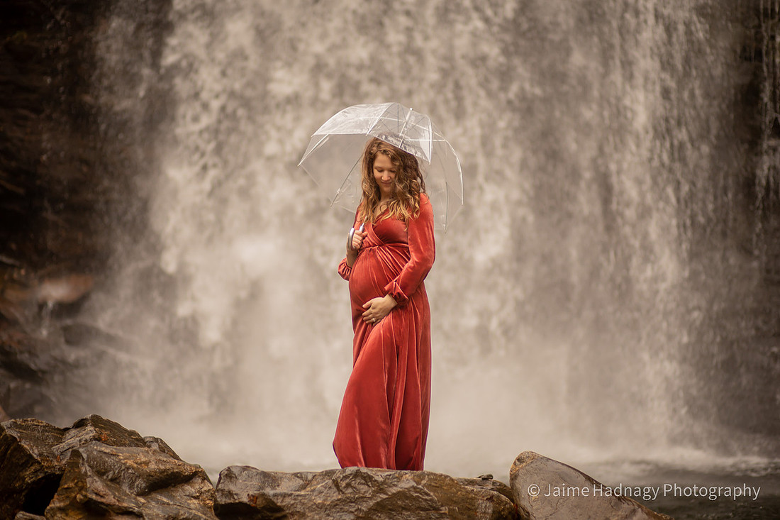 Gorgeous Pregnant Woman at a Waterfall with Umbrella and Red Velvet Dress | North Carolina Photographer