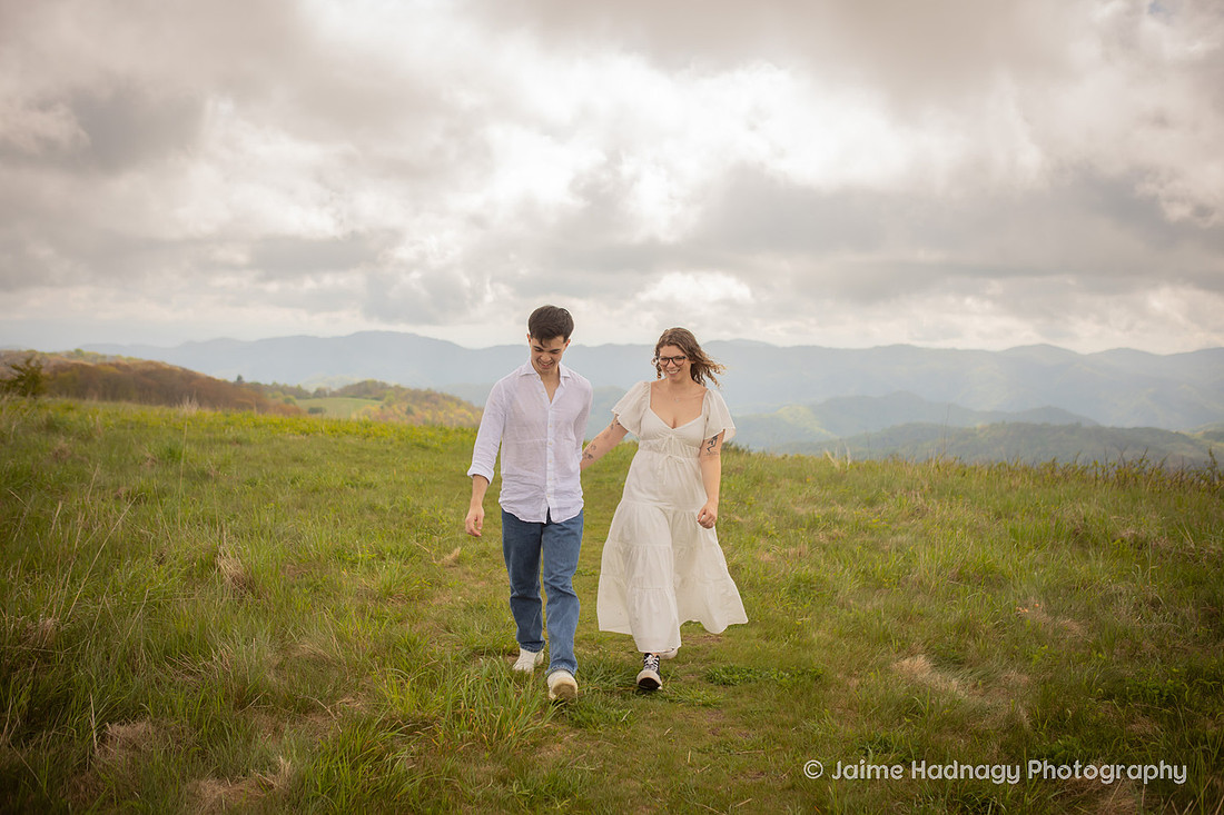 Dreamy Romantic Engagement Photos in a field in the mountains