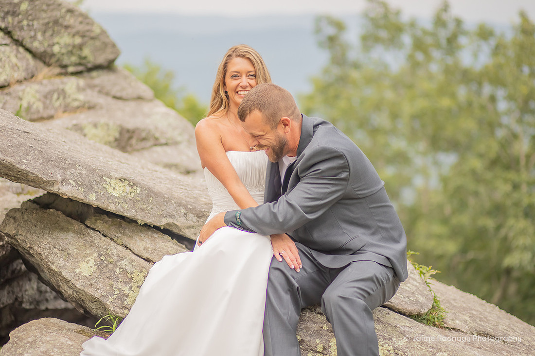 Bride and Groom sitting on rocks in nature | Asheville Wedding Photographer