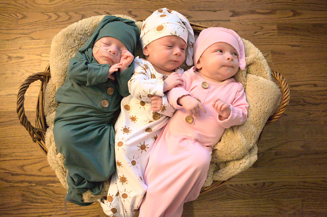 Newborn Triplets Two Are Awake and One is Asleep