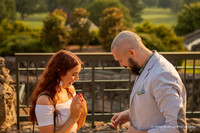 man giving his girlfriend an engagement ring after proposing to her