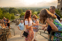 woman showing off her new engagement ring to her family after a surprise proposal