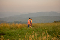 couple touching foreheads and holding hands in the mountains at Max Patch