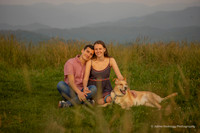 guy snuggling with his girlfriend and dog in a field at Max Patch