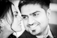 black and white image of a woman whispering in a man�s ear