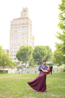 man dipping a woman in a red dress dancing in front of the Jackson Building in downtown Asheville