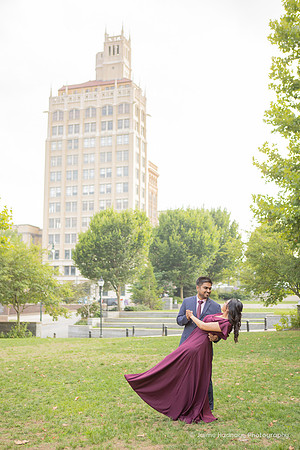 man dipping a woman in a red dress dancing in front of the Jackson Building in downtown Asheville