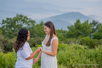 close up photo of two women hugging with engagement ring showing