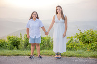 two women holding hands in the mountains