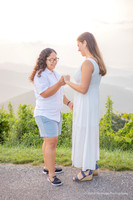 close up of a hand wearing an engagement ring while holding hands