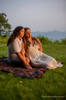 lesbian couple snuggling on a blanket on the blue ridge parkway at sunrise