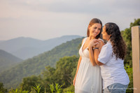 Lesbian couple caressing each other lovingly in the mountains