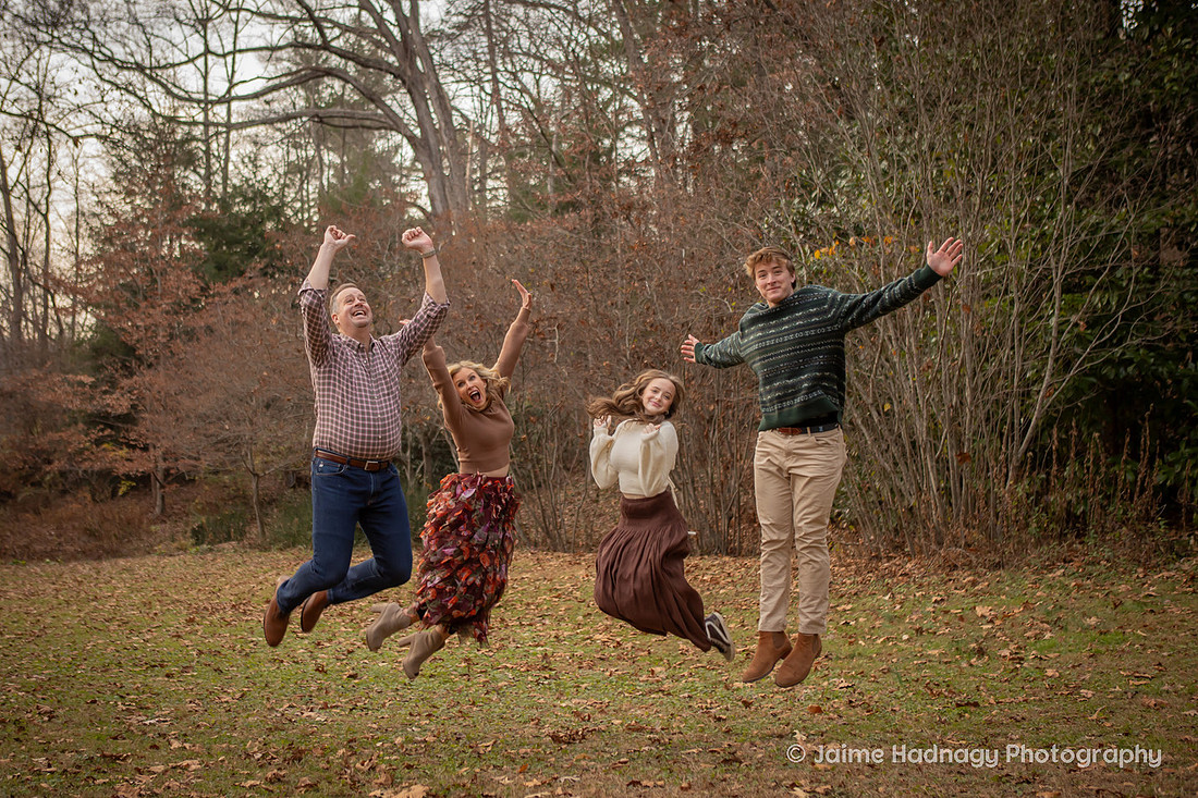 Family Jumping in the Air on  a Fall Day