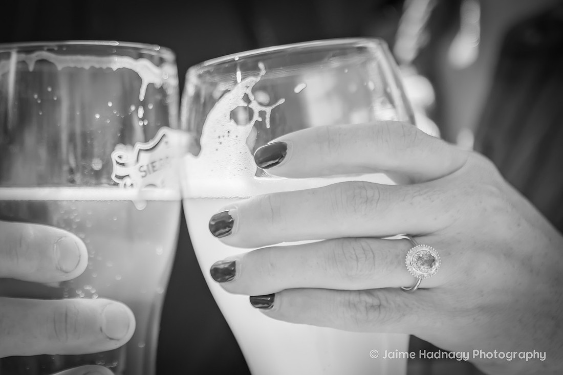 Black and white photo of beer with engagement ring